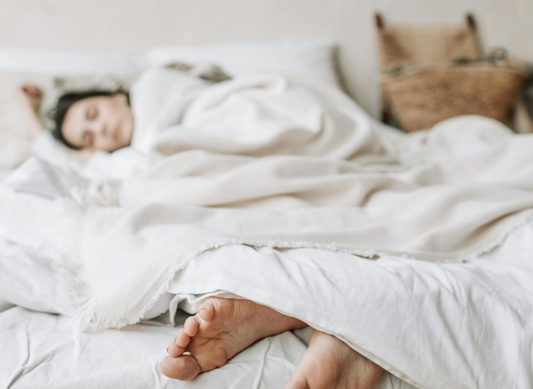 Woman Sleeping on a Bed with a White Blanket