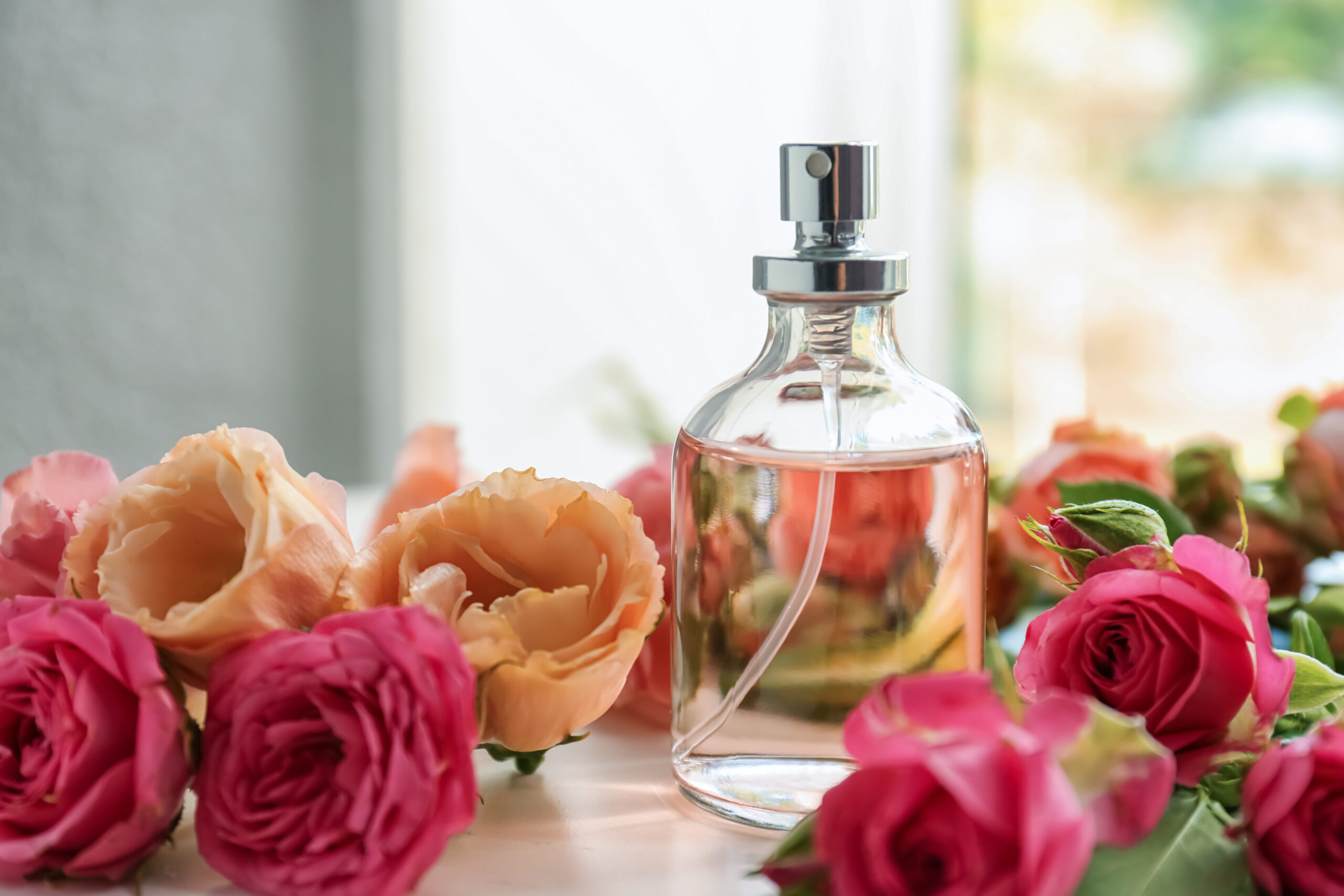 Bottle of perfume with beautiful flowers